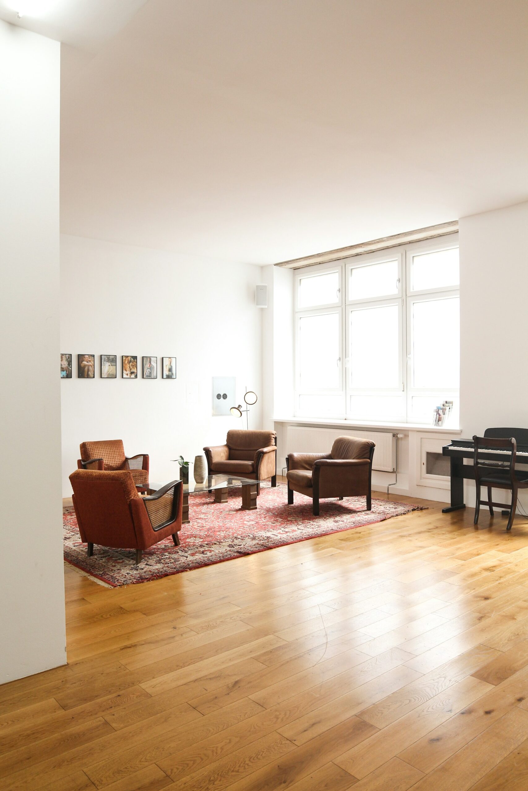 Spacious living room with wooden flooring and chairs